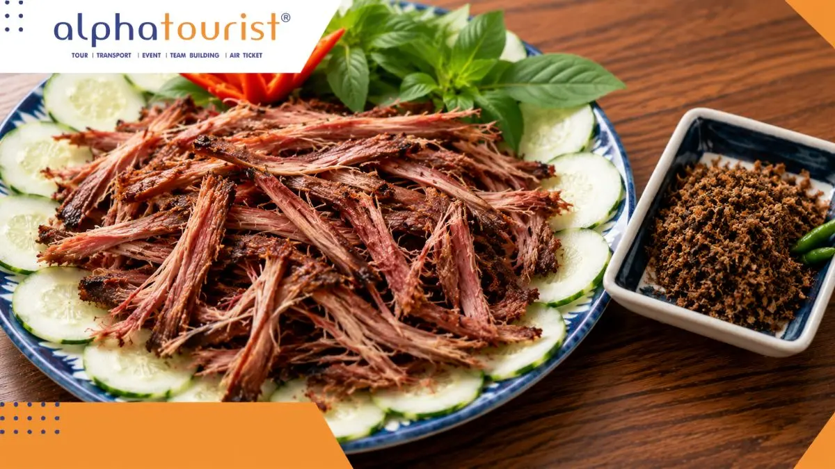 Đĩa bò một nắng đã nướng chín được cắt lát, bên cạnh là một chén nhỏ đựng muối kiến vàng đặc trưng của vùng đất Phú Yên